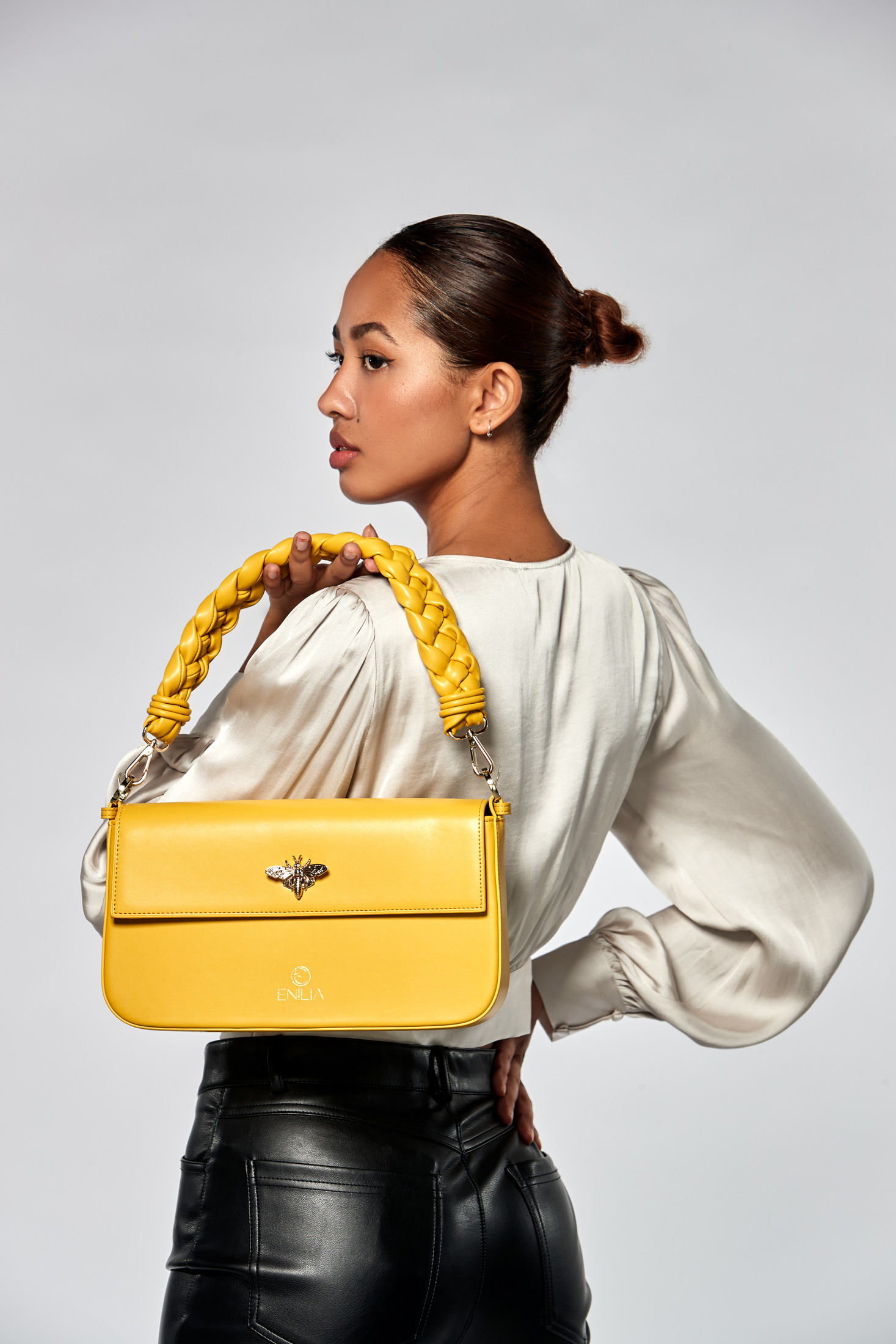 Model carrying the Enilia yellow handbag, e-commerce product photography
